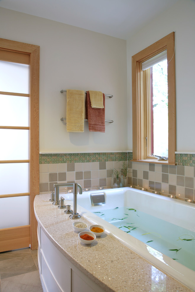 This is an example of a classic bathroom in DC Metro with white cabinets, a built-in bath and multi-coloured tiles.
