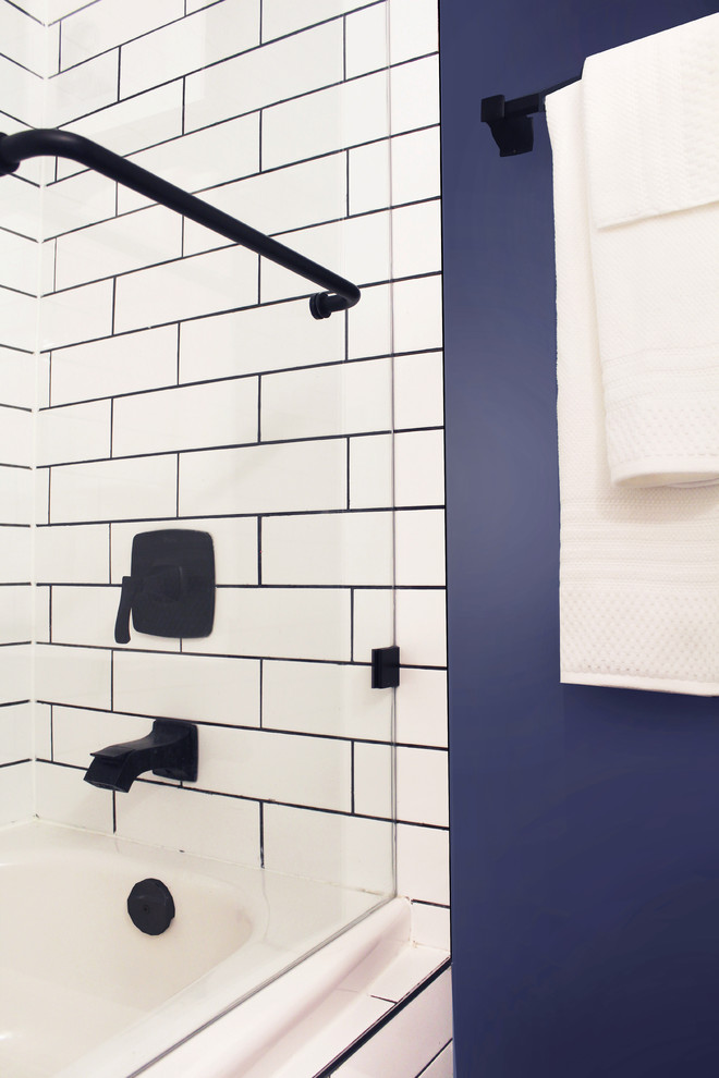 Small minimalist 3/4 white tile and ceramic tile ceramic tile, blue floor and single-sink bathroom photo in Toronto with flat-panel cabinets, black cabinets, a one-piece toilet, blue walls, a drop-in sink, marble countertops, white countertops and a floating vanity