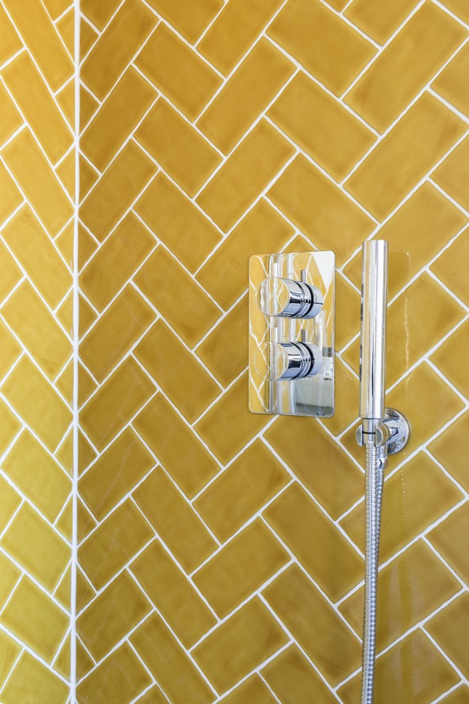 Inspiration for a small contemporary master yellow tile and ceramic tile concrete floor corner shower remodel in London with open cabinets, light wood cabinets, a wall-mount toilet, white walls and a wall-mount sink