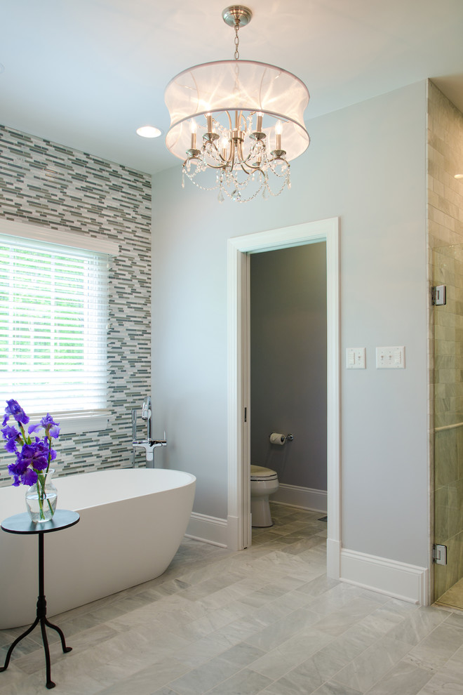 Idéer för ett stort klassiskt en-suite badrum, med luckor med infälld panel, skåp i mörkt trä, ett fristående badkar, grå kakel, vit kakel, stickkakel, grå väggar, klinkergolv i porslin och granitbänkskiva