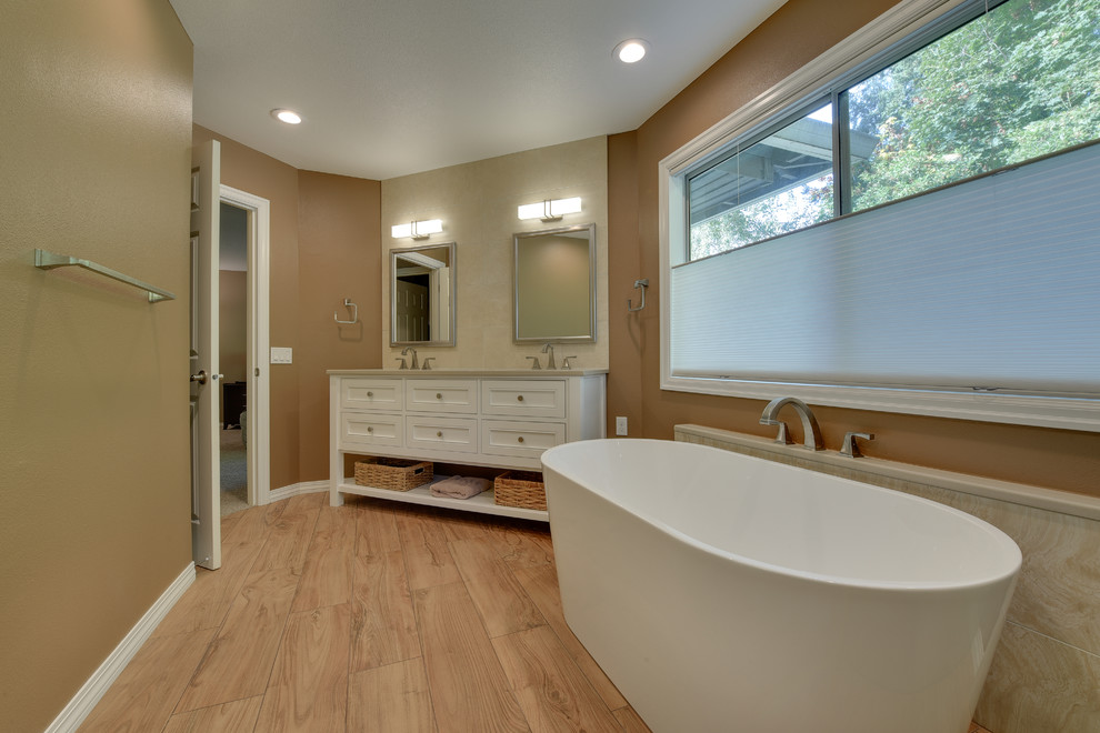 Large transitional master beige tile and porcelain tile porcelain tile and brown floor bathroom photo in Portland with recessed-panel cabinets, beige cabinets, brown walls, an undermount sink, quartz countertops and a hinged shower door