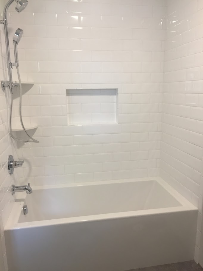 Inspiration for a medium sized classic ensuite bathroom in Chicago with shaker cabinets, medium wood cabinets, an alcove bath, a shower/bath combination, a two-piece toilet, white tiles, metro tiles, grey walls, porcelain flooring, a submerged sink, engineered stone worktops, grey floors and a shower curtain.