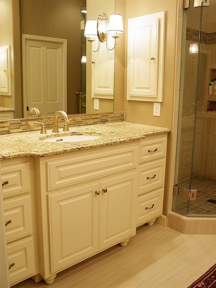 This is an example of a large romantic ensuite bathroom in Minneapolis with a submerged sink, raised-panel cabinets, white cabinets, granite worktops, a corner shower, beige tiles, ceramic tiles, beige walls and ceramic flooring.