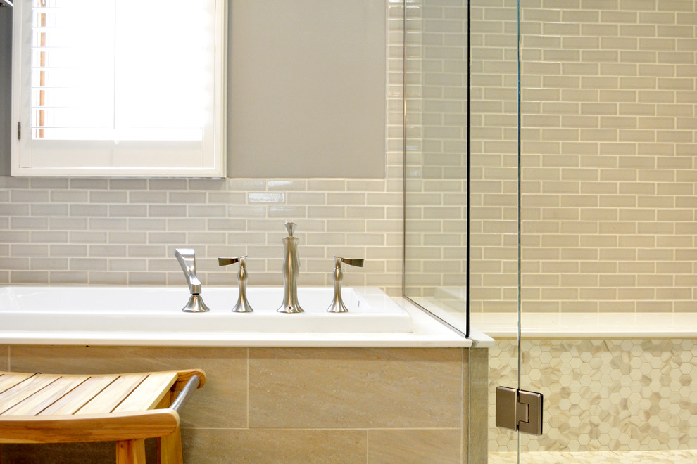 На фото: главная ванная комната среднего размера в стиле неоклассика (современная классика) с столешницей из искусственного кварца, накладной ванной, угловым душем, бежевой плиткой, керамической плиткой, бежевыми стенами и полом из керамогранита