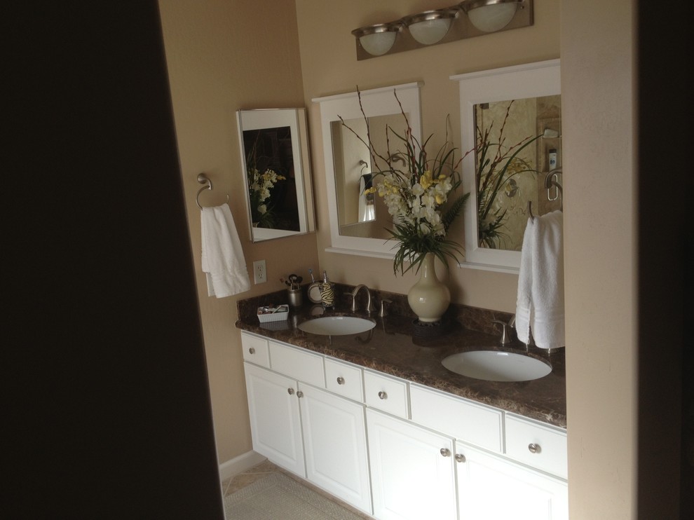 Example of a mid-sized classic master beige tile and ceramic tile ceramic tile corner shower design in Phoenix with an undermount sink, raised-panel cabinets, white cabinets, granite countertops, a two-piece toilet and beige walls