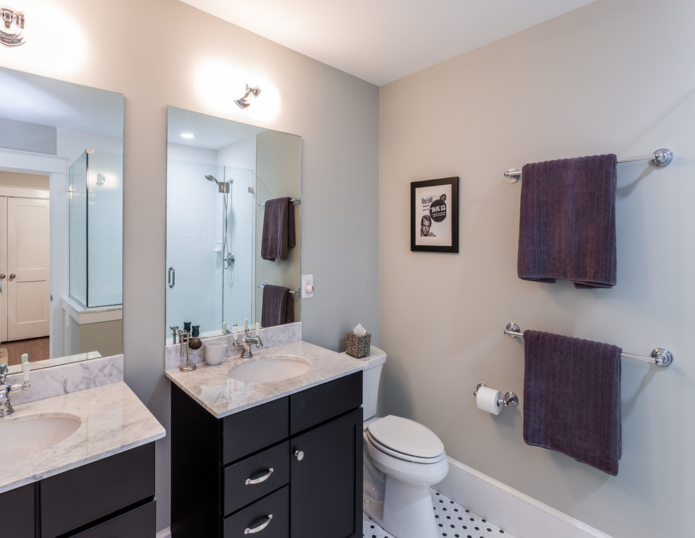 Photo of a small traditional ensuite bathroom in DC Metro with shaker cabinets, black cabinets, a walk-in shower, a two-piece toilet, black and white tiles, ceramic tiles, grey walls, a submerged sink, marble worktops and ceramic flooring.