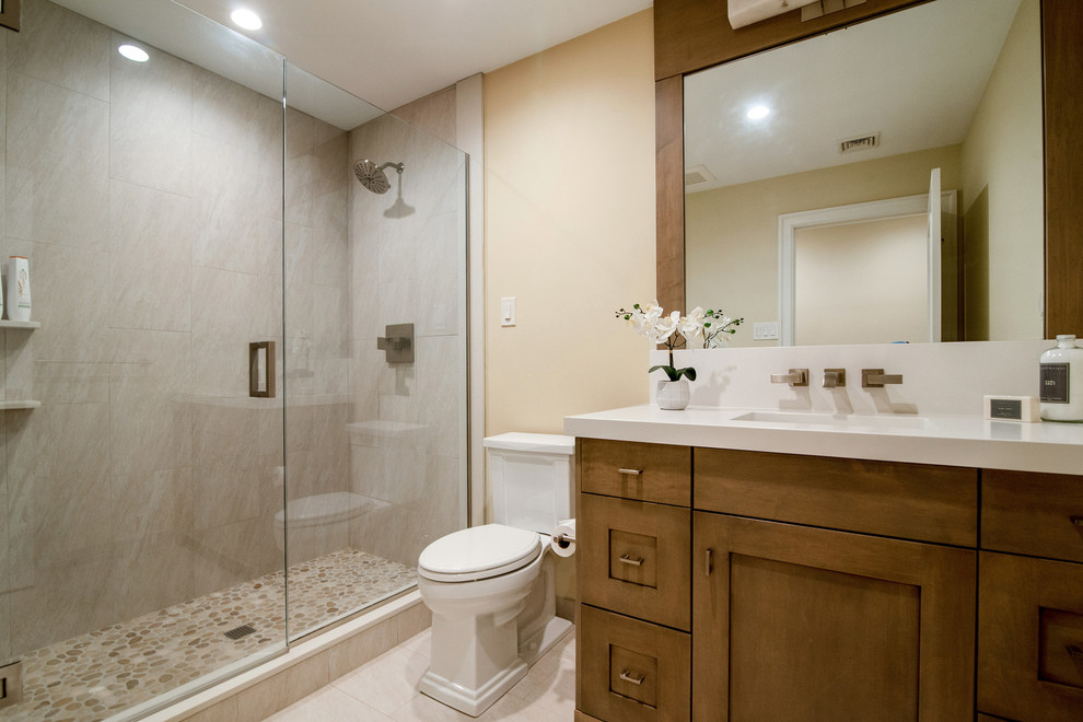 Photo of a medium sized rural shower room bathroom in Philadelphia with recessed-panel cabinets, medium wood cabinets, a double shower, a two-piece toilet, porcelain flooring, a submerged sink, marble worktops, beige floors, a hinged door and white worktops.
