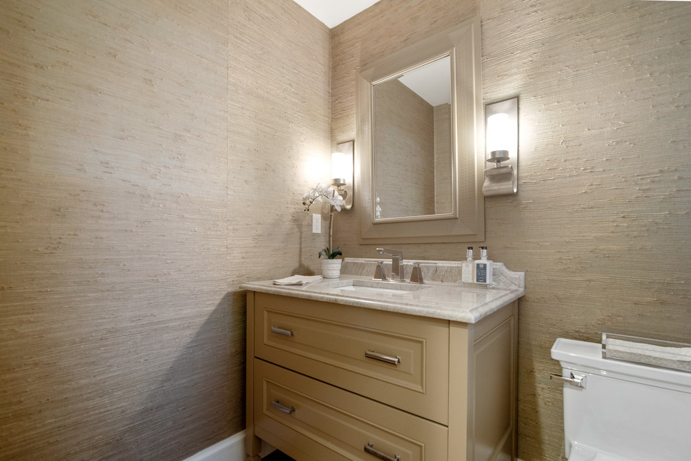 Cette image montre une petite salle de bain rustique avec un placard avec porte à panneau surélevé, des portes de placard beiges, WC séparés, un lavabo encastré, un plan de toilette en marbre et un plan de toilette beige.