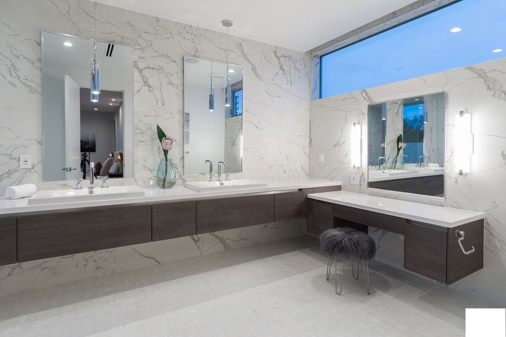 Inspiration for a medium sized contemporary ensuite bathroom in Los Angeles with flat-panel cabinets, dark wood cabinets, white worktops, white tiles, marble tiles, white walls, marble flooring, a submerged sink, engineered stone worktops and white floors.