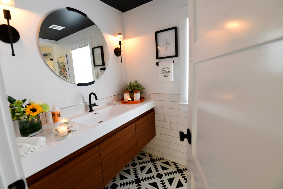 На фото: детская ванная комната среднего размера в стиле модернизм с фасадами островного типа, светлыми деревянными фасадами, накладной ванной, белыми стенами, накладной раковиной, душем с раздвижными дверями и встроенной тумбой