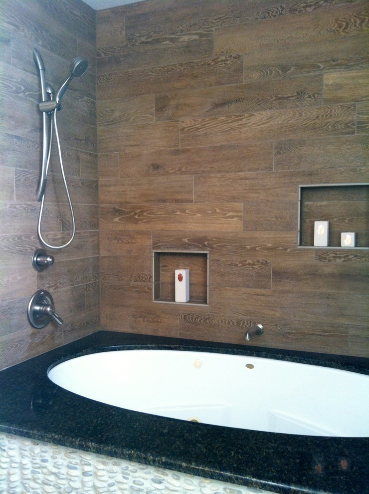 Cette photo montre une salle de bain principale moderne de taille moyenne avec un lavabo suspendu, une baignoire indépendante, une douche ouverte et un carrelage de pierre.