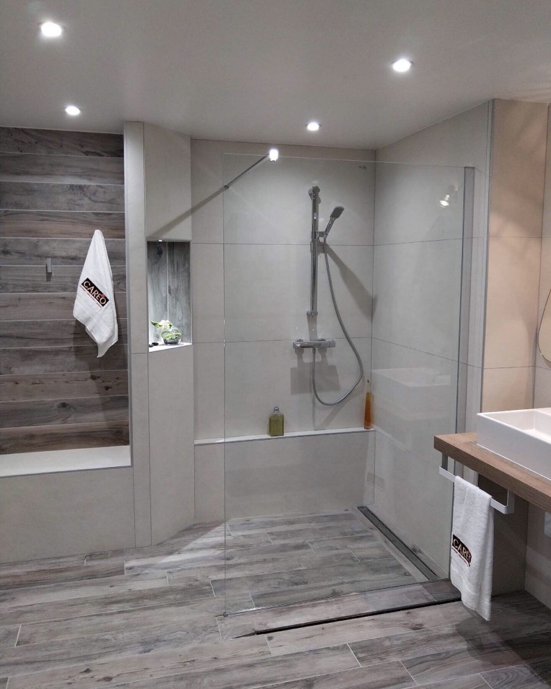 This is an example of a large modern ensuite bathroom in Other with flat-panel cabinets, black cabinets, beige tiles, white tiles, grey tiles, wooden worktops, beige worktops, a single sink, a floating vanity unit, a walk-in shower, cement tiles, a trough sink, grey floors and an open shower.