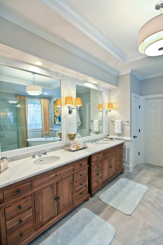 Bathroom - mid-sized craftsman master gray tile and porcelain tile porcelain tile bathroom idea in Atlanta with shaker cabinets, medium tone wood cabinets, a two-piece toilet, gray walls, an undermount sink and marble countertops