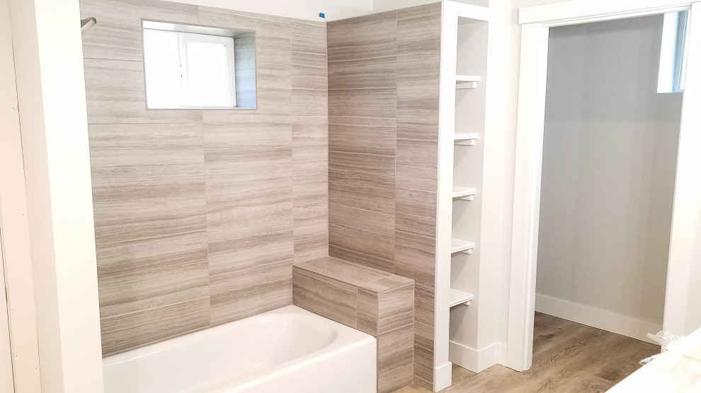 Bathroom - mid-sized modern kids' gray tile and porcelain tile vinyl floor and gray floor bathroom idea in Seattle with shaker cabinets, gray cabinets, a one-piece toilet, white walls, a drop-in sink, quartz countertops, a hinged shower door and white countertops