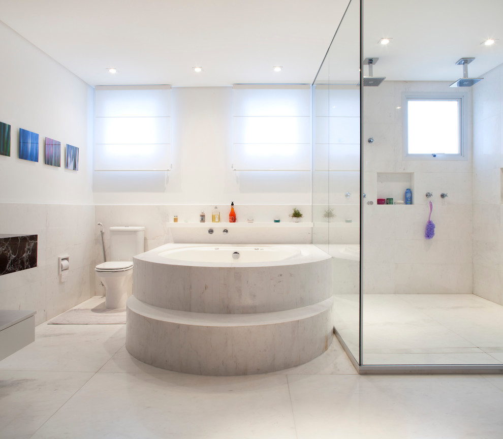 Photo of a large contemporary bathroom in Other with an integrated sink, marble worktops, a freestanding bath, a double shower, a one-piece toilet and marble flooring.
