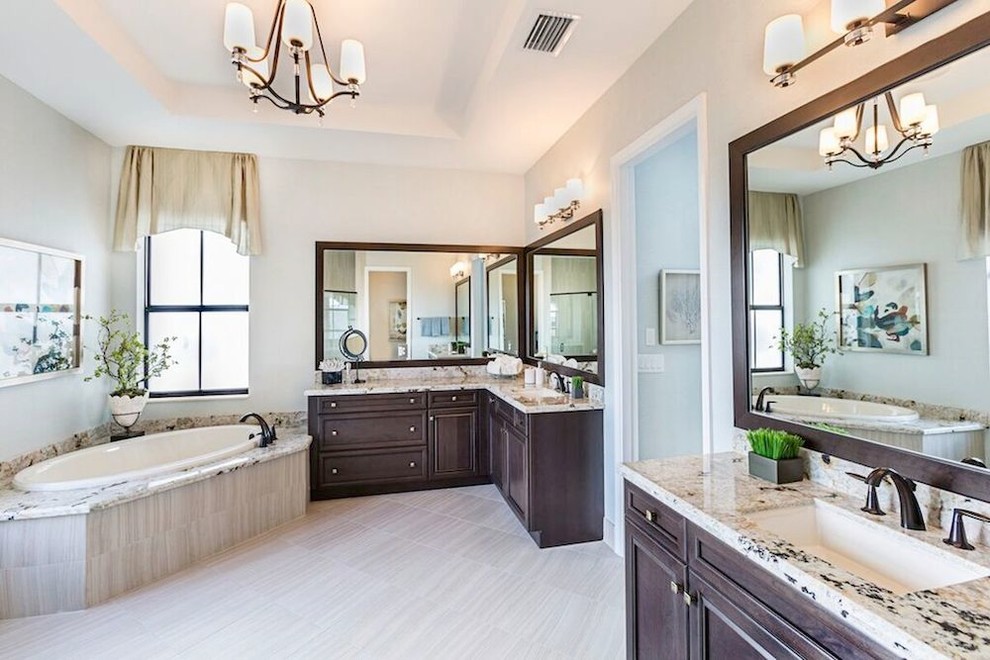 Large elegant master porcelain tile bathroom photo in Miami with shaker cabinets, dark wood cabinets, white walls, an undermount sink and granite countertops