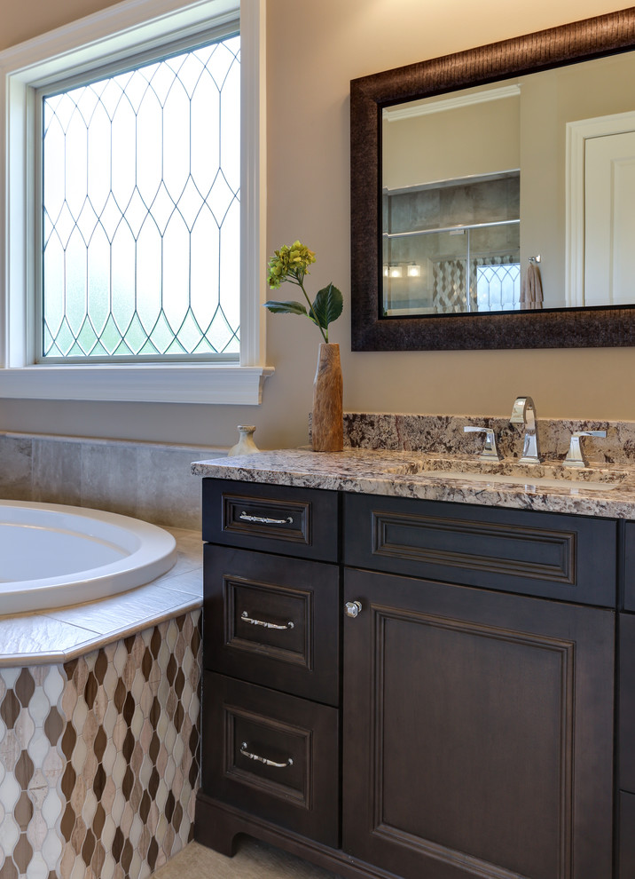 Inspiration for a large transitional 3/4 multicolored tile and mosaic tile ceramic tile bathroom remodel in Raleigh with an undermount sink, recessed-panel cabinets, gray cabinets, granite countertops, a two-piece toilet and beige walls