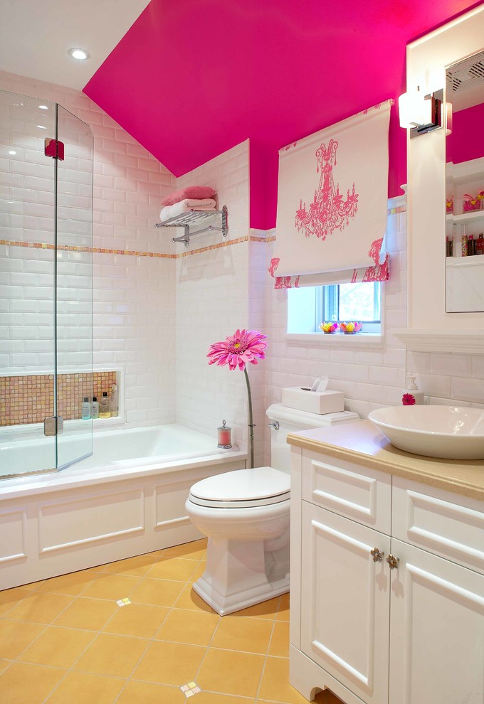 Elegant kids' white tile and subway tile yellow floor bathroom photo in Montreal with a vessel sink, recessed-panel cabinets, white cabinets, a two-piece toilet and pink walls