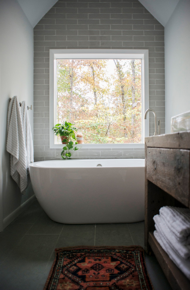 Idéer för små badrum, med ett fristående badkar, grå kakel, tunnelbanekakel, skiffergolv, ett fristående handfat, träbänkskiva och grått golv
