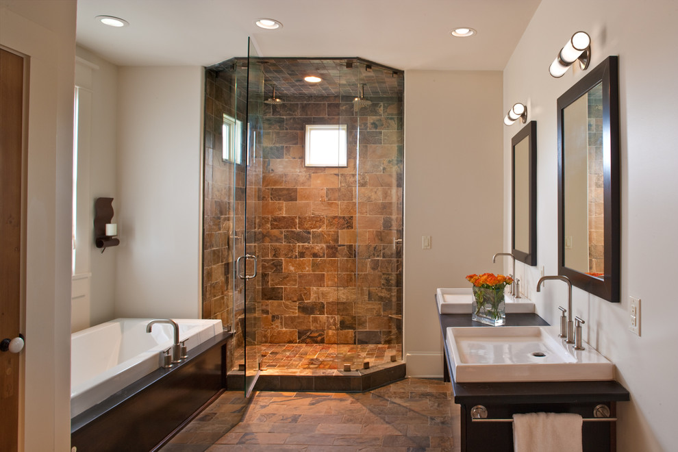 Example of an eclectic brown tile bathroom design in New Orleans with a drop-in sink, furniture-like cabinets, dark wood cabinets and white walls