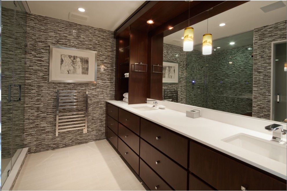 Mid-sized elegant master multicolored tile and matchstick tile porcelain tile and white floor corner shower photo in New York with flat-panel cabinets, dark wood cabinets, multicolored walls, an undermount sink, solid surface countertops and a hinged shower door