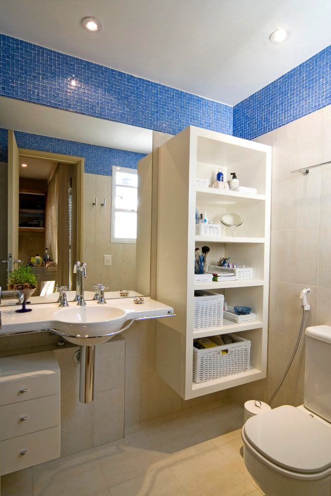 Contemporary bathroom in Other with a wall-mounted sink, open cabinets and blue tiles.