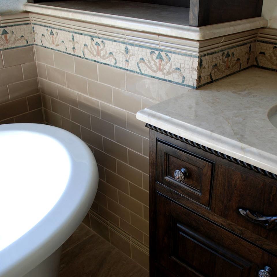 Inspiration for a traditional bathroom in Orlando with dark wood cabinets, a freestanding bath, beige tiles, cement tiles and a submerged sink.