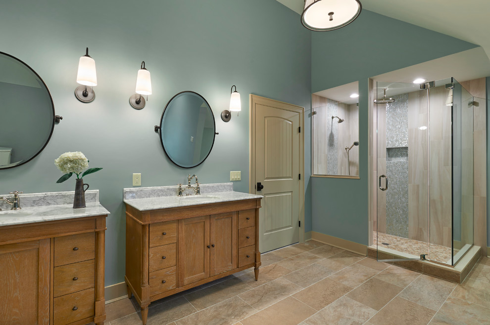 Elegant master beige tile medium tone wood floor and multicolored floor bathroom photo in New York with shaker cabinets, distressed cabinets, a two-piece toilet, gray walls, an integrated sink and granite countertops