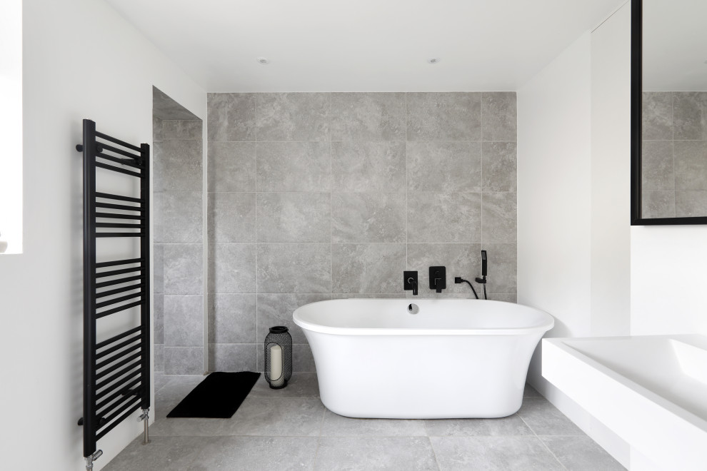 Inspiration for a mid-sized contemporary master gray tile gray floor freestanding bathtub remodel in Sussex with white walls and a pedestal sink