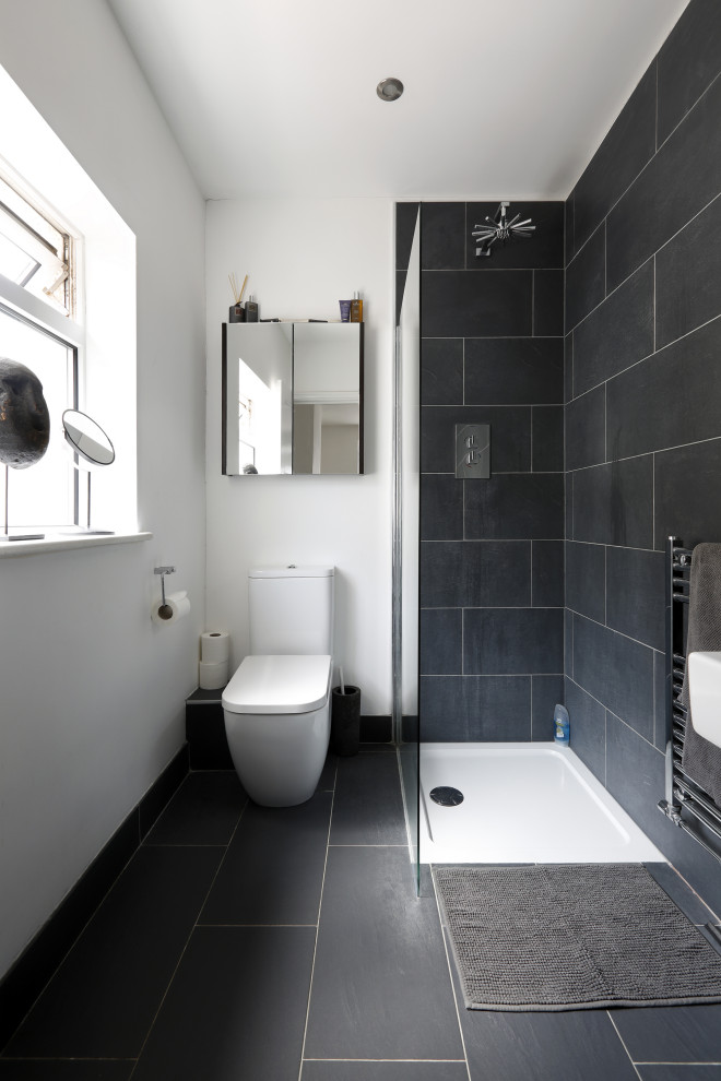 This is an example of a medium sized contemporary shower room bathroom in Sussex with a corner shower, a two-piece toilet, grey tiles, porcelain tiles, white walls, porcelain flooring, grey floors, a wall-mounted sink and an open shower.