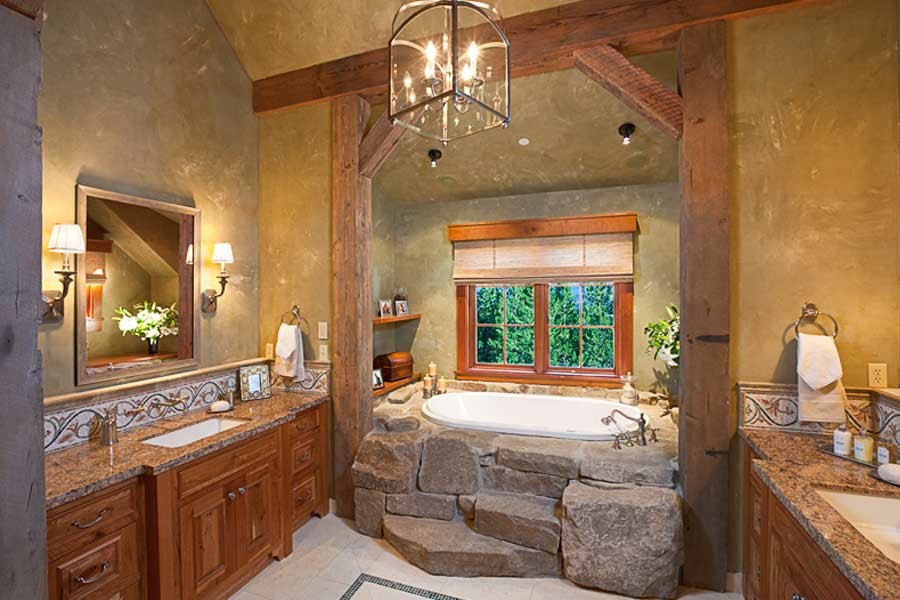 Photo of a large rustic ensuite bathroom in Other with a submerged sink, medium wood cabinets, granite worktops, a built-in bath, brown walls, recessed-panel cabinets, mosaic tiles, ceramic flooring and white floors.