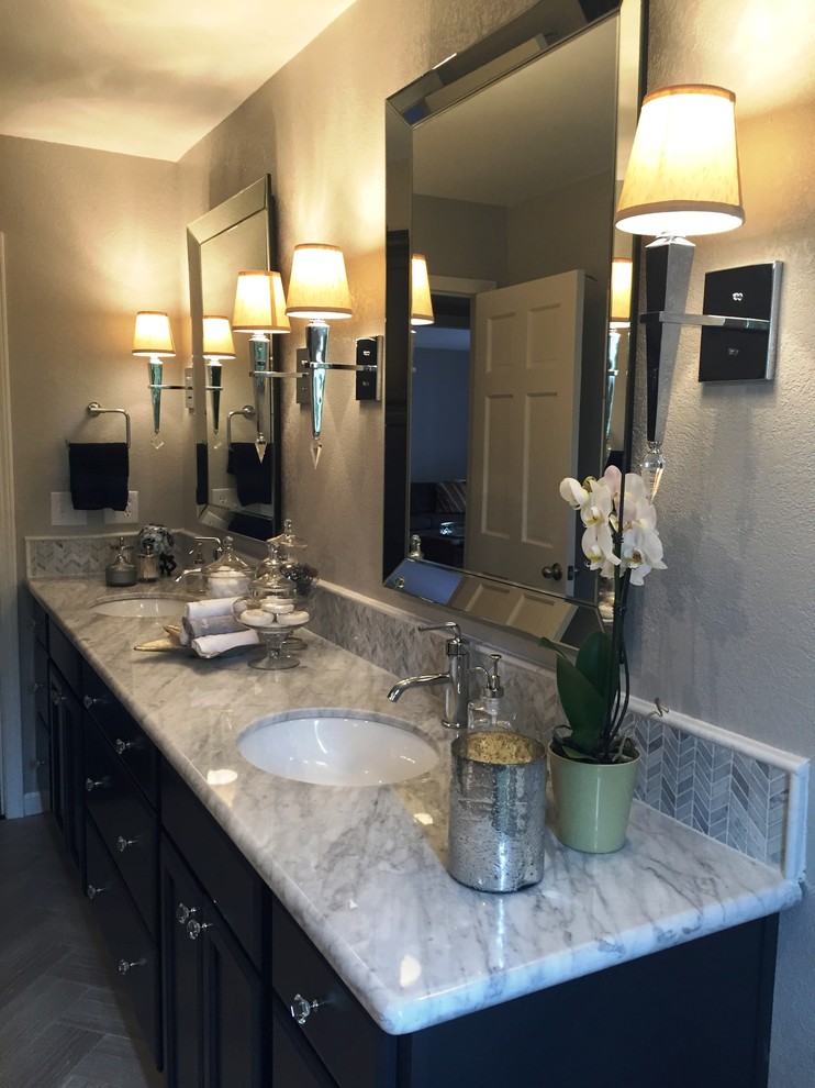 This is an example of a medium sized traditional ensuite bathroom in Sacramento with grey walls, dark hardwood flooring, a submerged sink, grey floors, a hinged door, an alcove shower, grey tiles, stone tiles, quartz worktops, grey worktops, recessed-panel cabinets and black cabinets.