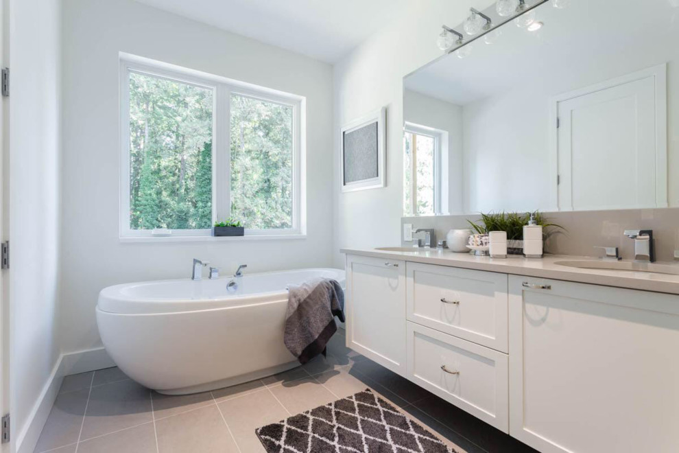 Bathroom - mid-sized modern master white tile and pebble tile porcelain tile and gray floor bathroom idea in Vancouver with shaker cabinets, white cabinets, a one-piece toilet, multicolored walls, an undermount sink, tile countertops and gray countertops