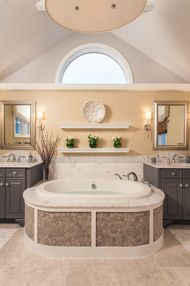 Example of a large transitional master gray tile and stone tile marble floor bathroom design in Boston with an undermount sink, raised-panel cabinets, gray cabinets, marble countertops and beige walls