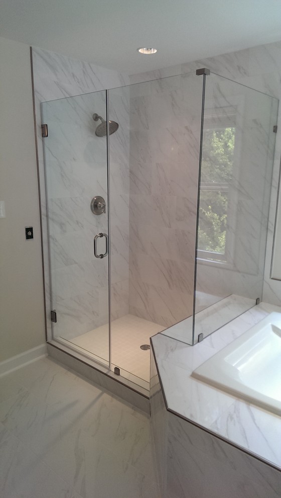 Example of a mid-sized trendy master gray tile and stone slab marble floor and gray floor corner shower design in DC Metro with raised-panel cabinets, dark wood cabinets, white walls, an undermount sink and marble countertops