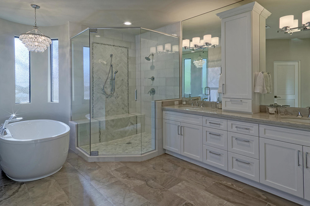 Inspiration for a large classic bathroom in Phoenix with shaker cabinets, white cabinets, a freestanding bath, a double shower, grey tiles, stone tiles, white walls and a submerged sink.
