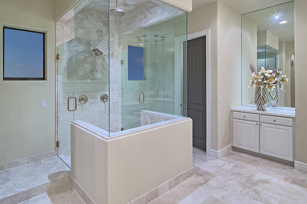 Large elegant master beige tile and porcelain tile vinyl floor corner shower photo in Phoenix with recessed-panel cabinets, white cabinets, a hot tub, a one-piece toilet, beige walls, a drop-in sink and soapstone countertops