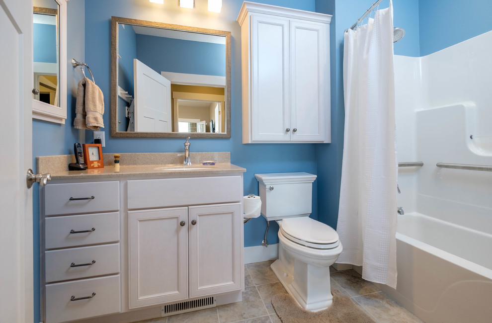 Inspiration pour une petite salle de bain principale traditionnelle avec un placard avec porte à panneau encastré, des portes de placard blanches, une baignoire en alcôve, un combiné douche/baignoire, WC séparés, un carrelage blanc, un carrelage de pierre, un mur bleu, un sol en travertin, un lavabo encastré et un plan de toilette en granite.