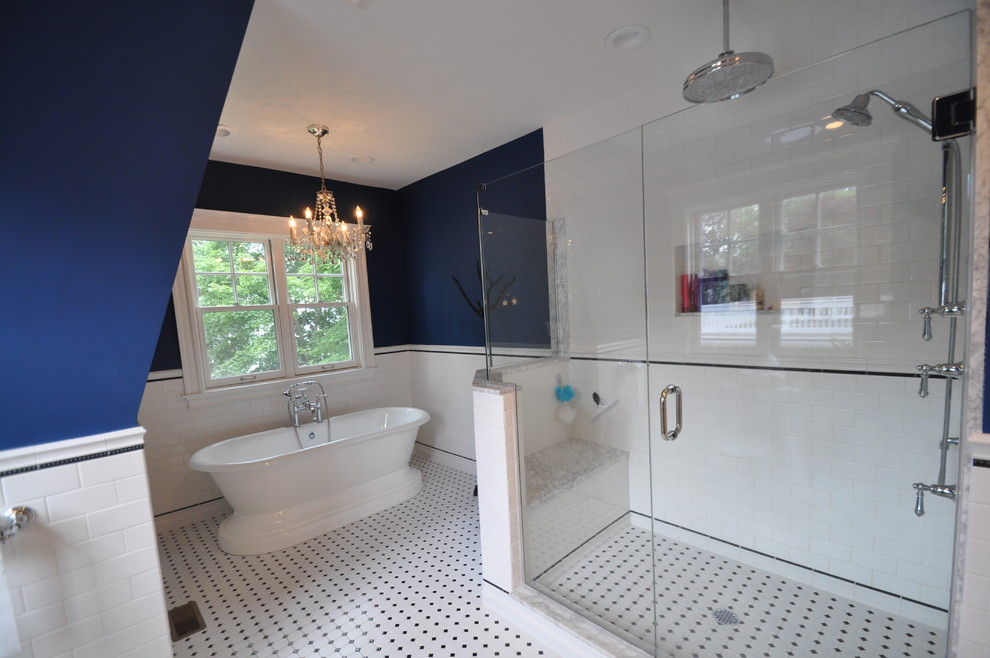 На фото: большая главная ванная комната в стиле неоклассика (современная классика) с фасадами с выступающей филенкой, белыми фасадами, отдельно стоящей ванной, угловым душем, белой плиткой, керамической плиткой, синими стенами, полом из керамической плитки, накладной раковиной, столешницей из гранита, белым полом и душем с распашными дверями с