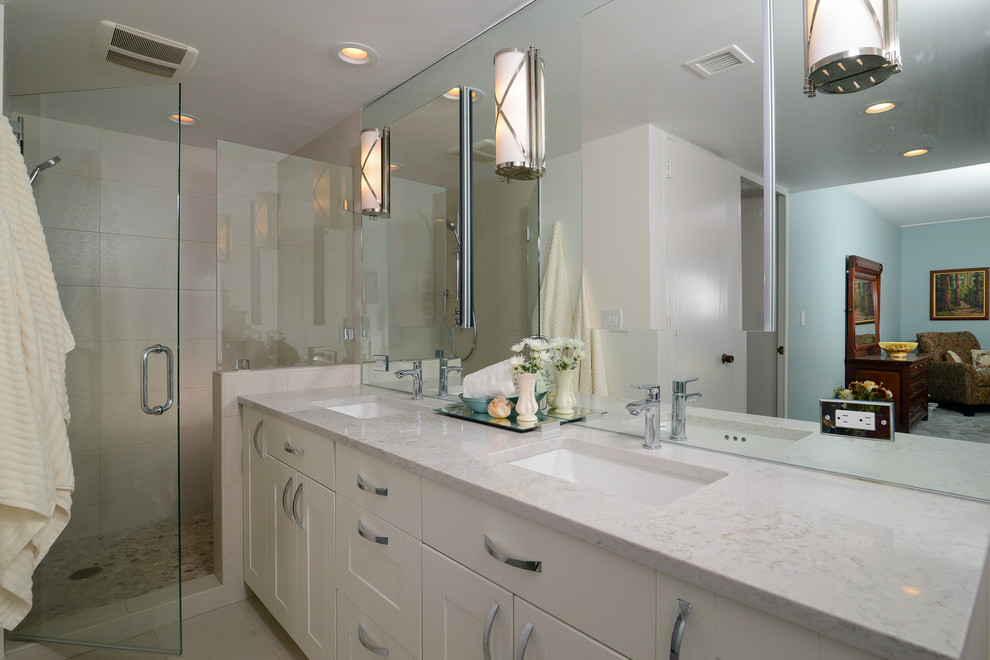 This is an example of a medium sized contemporary ensuite bathroom in Sacramento with a submerged sink, recessed-panel cabinets, white cabinets, an alcove shower, white tiles, porcelain tiles and white walls.