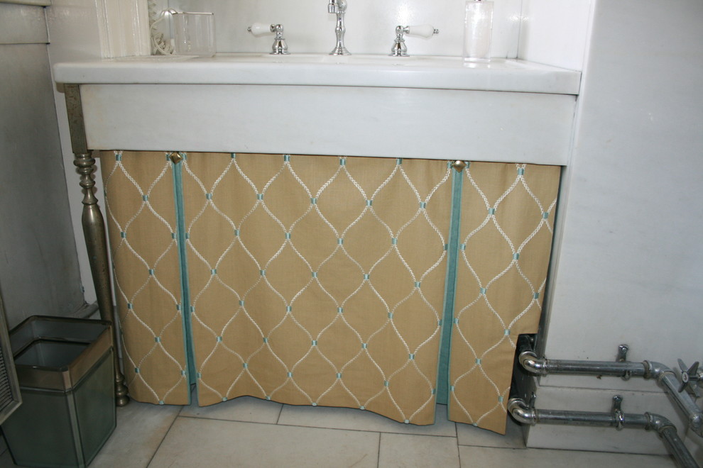 Photo of a traditional bathroom in DC Metro with a corner shower, yellow walls, marble flooring and a shower curtain.