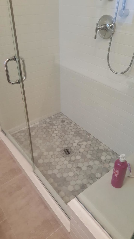 Medium sized contemporary ensuite bathroom in Chicago with an alcove shower, white tiles, metro tiles, white walls and concrete flooring.