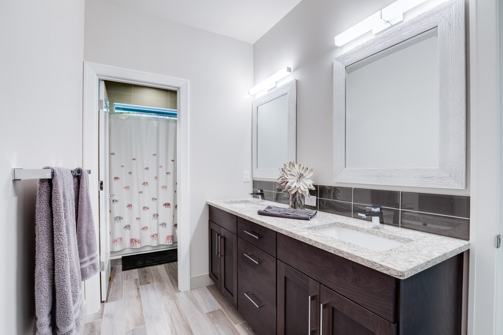 This is an example of a medium sized modern shower room bathroom in Seattle with shaker cabinets, dark wood cabinets, black tiles, metro tiles, beige walls, porcelain flooring, a submerged sink, solid surface worktops, grey floors, a shower curtain and white worktops.