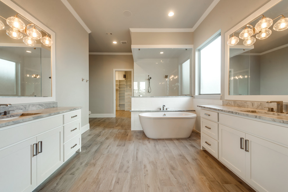 Inspiration for a large transitional master white tile and ceramic tile light wood floor doorless shower remodel in Dallas with shaker cabinets, white cabinets, a two-piece toilet, beige walls, an undermount sink and quartz countertops