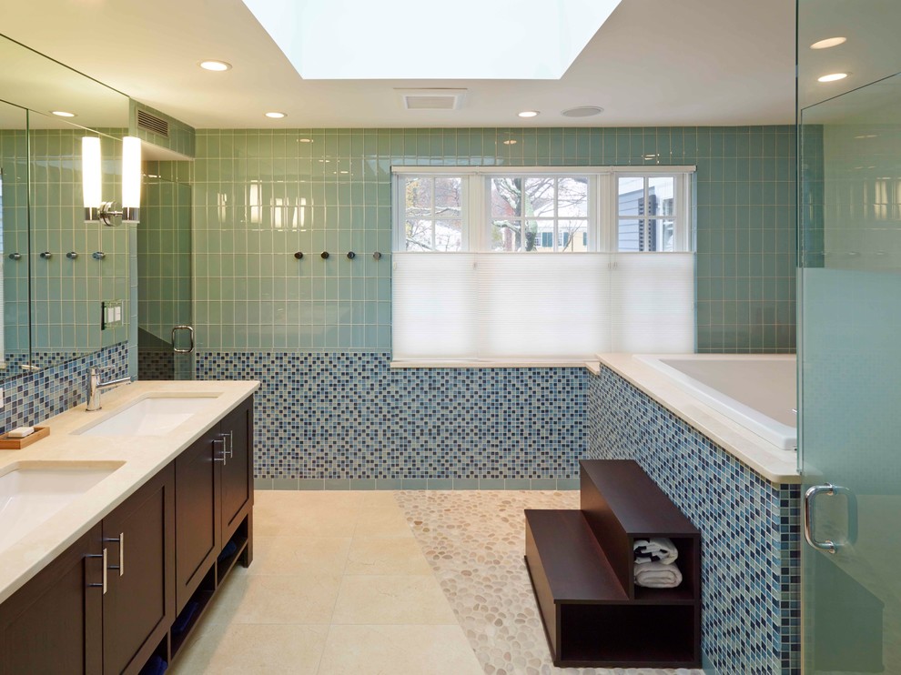 Photo of a large traditional ensuite bathroom in Boston with shaker cabinets, dark wood cabinets, a hot tub, an alcove shower, blue tiles, glass tiles, blue walls, porcelain flooring, a submerged sink, engineered stone worktops, beige floors and a hinged door.