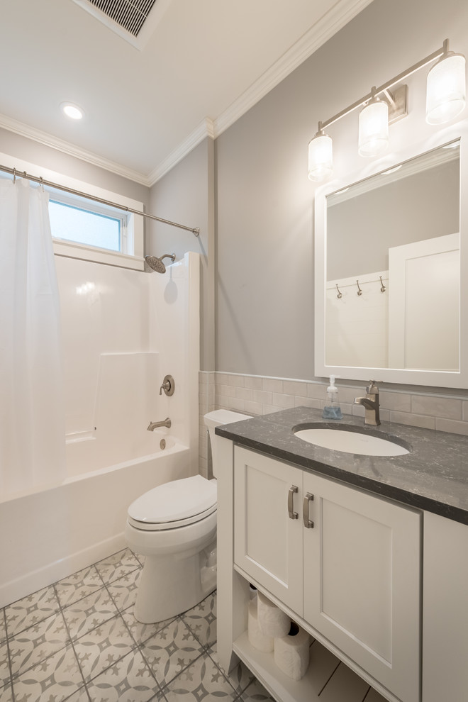 Inspiration for a small traditional shower room bathroom in Minneapolis with shaker cabinets, white cabinets, an alcove bath, an alcove shower, a one-piece toilet, grey walls, cement flooring, a submerged sink, white floors, a shower curtain and grey worktops.