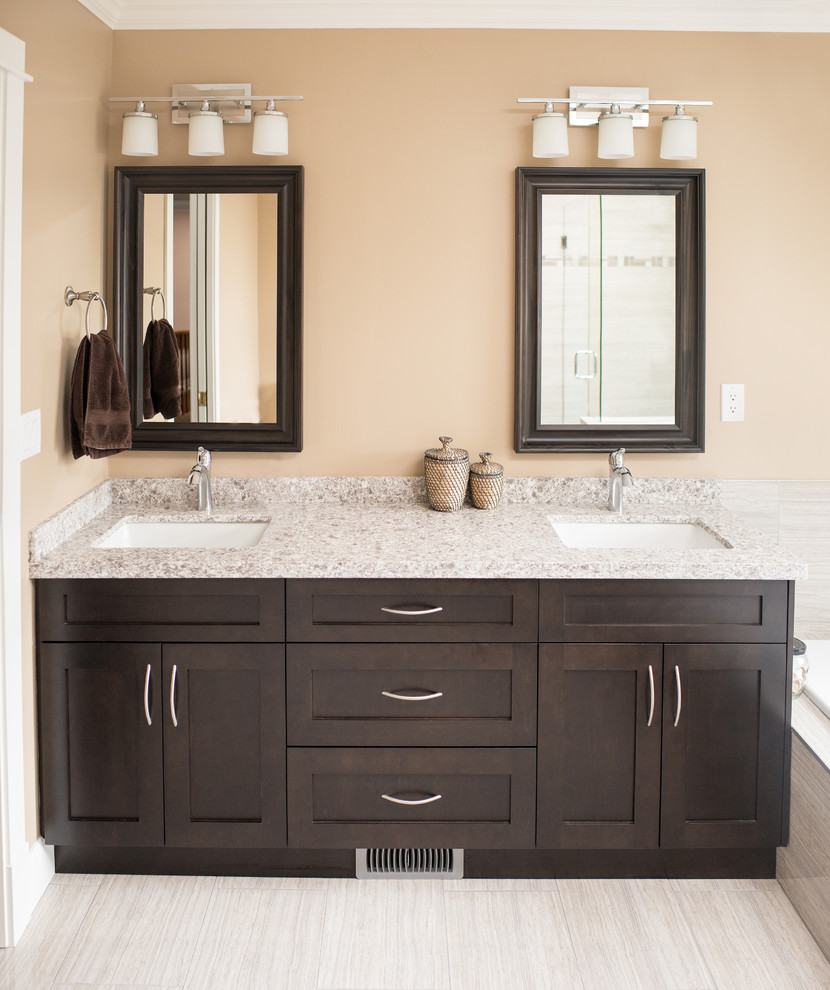 Example of a trendy beige tile and ceramic tile bathroom design in Vancouver with an undermount sink, shaker cabinets, dark wood cabinets, quartzite countertops and a two-piece toilet