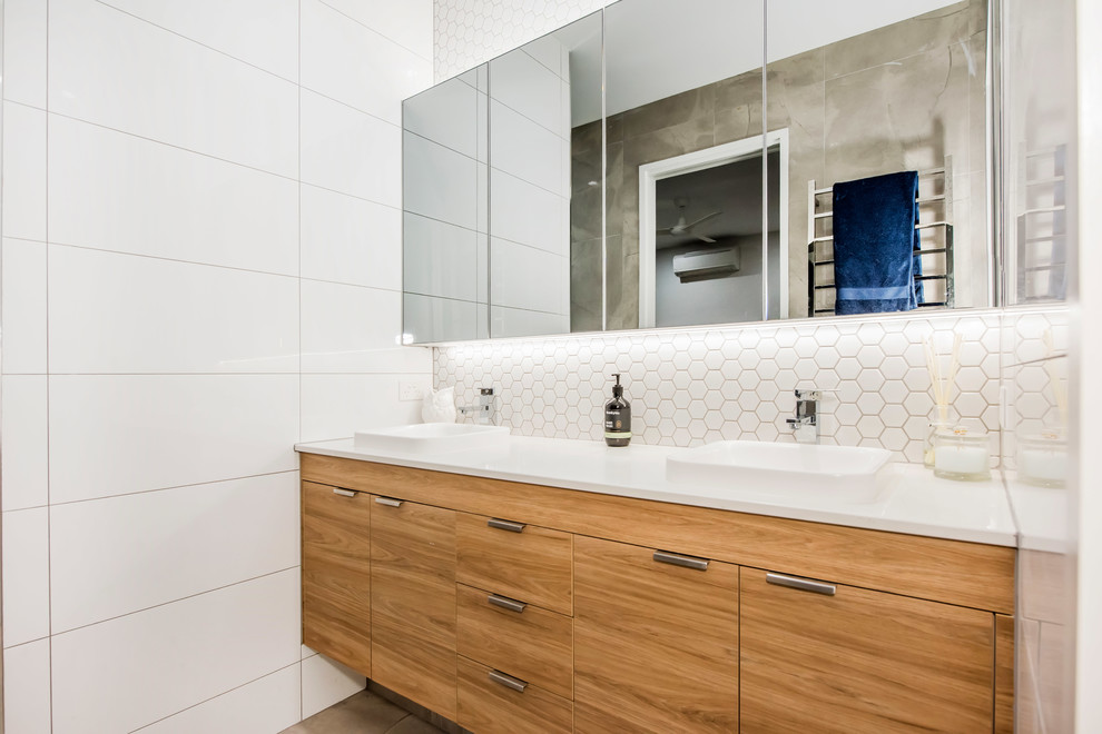 Inspiration for a medium sized contemporary ensuite bathroom in Other with flat-panel cabinets, light wood cabinets, a double shower, a one-piece toilet, white tiles, mosaic tiles, white walls, ceramic flooring, a vessel sink, granite worktops, grey floors, an open shower, white worktops, double sinks and a floating vanity unit.