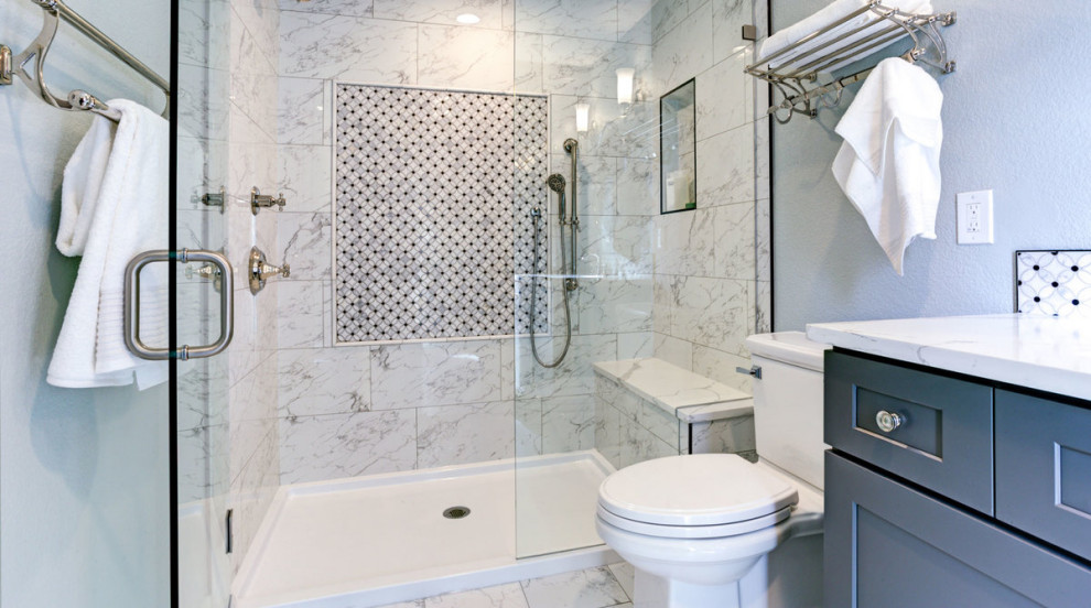 Photo of a small contemporary shower room bathroom in Other with shaker cabinets, grey cabinets, an alcove shower, a two-piece toilet, white tiles, marble tiles, white walls, marble flooring, a submerged sink, quartz worktops, white floors, a hinged door and white worktops.