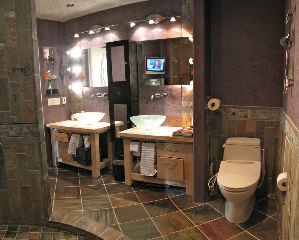 This is an example of a medium sized contemporary ensuite bathroom in Calgary with a vessel sink, glass-front cabinets, black cabinets, concrete worktops, a one-piece toilet, multi-coloured tiles, stone tiles, purple walls and slate flooring.